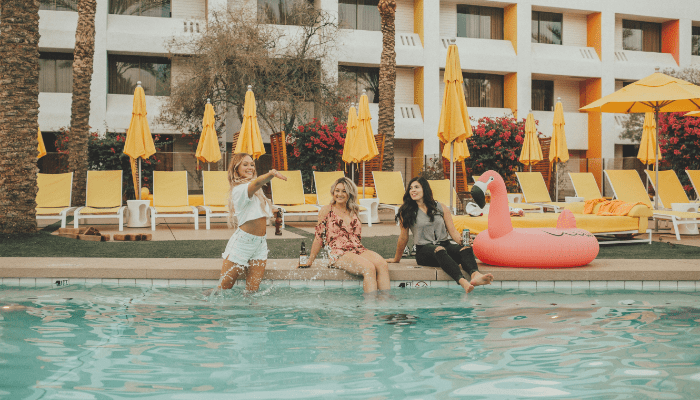 women sitting at a swimming pool